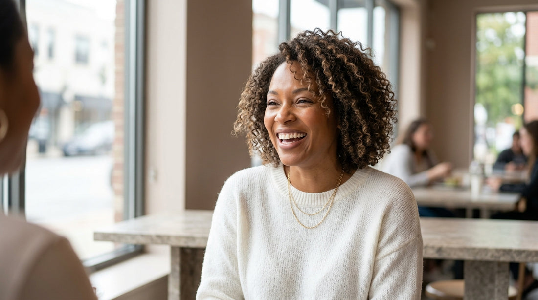Woman with long honey-blonde wavy wig laughing outdoors — capturing everyday wig lifestyle in a candid photo moment.